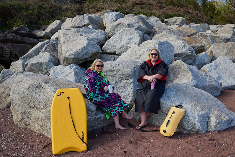 Lisa Haines Owens and Louisa Seymour of Mermaid Mortgages in their sea swimming attire. who are Mortgage Advisors based in Paignton, Devon.